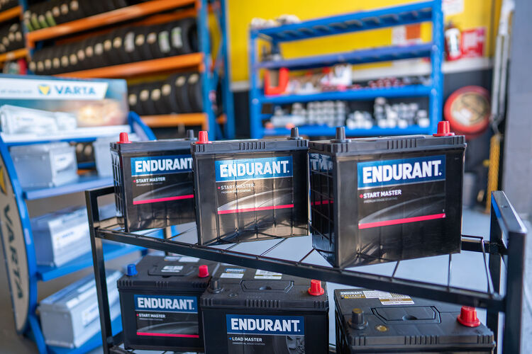 Endurant car batteries neatly stacked on a rack at Hamilton Auto Centre